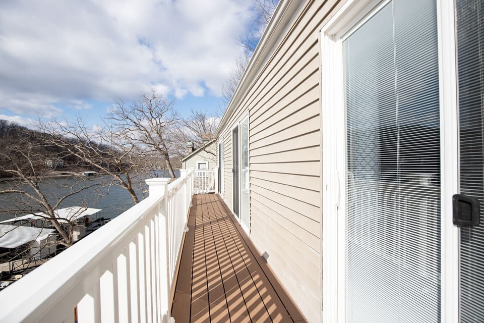 Lakefront balcony connecting master and king bedrooms