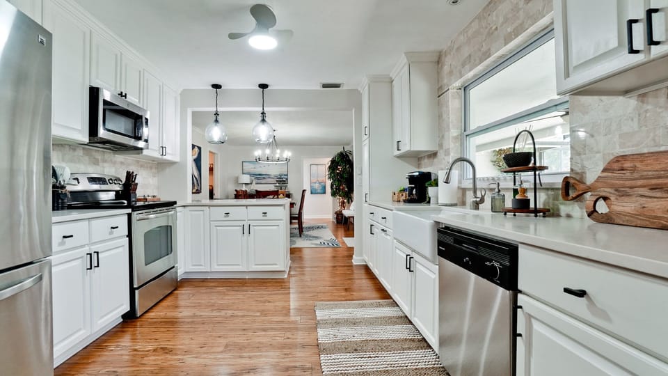 Large, fully furnished kitchen with stainless steel appliances. 