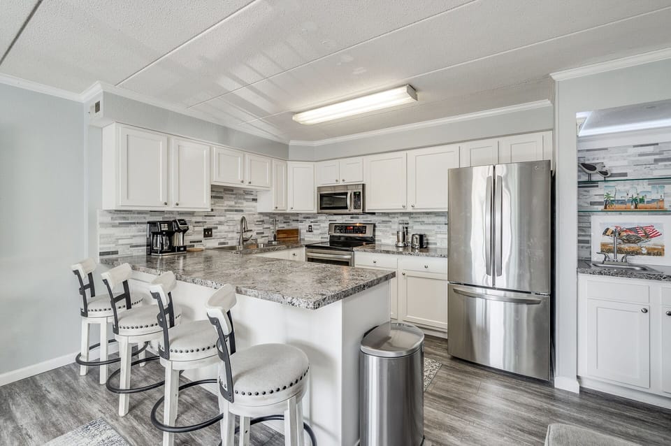 Gorgeous kitchen with breakfast bar and endless cabinet and workspace