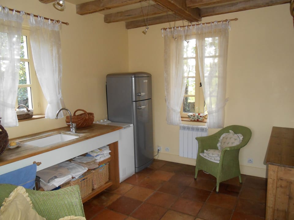 Utility room with extra fridge freezer, washing machine and downstairs toilet.