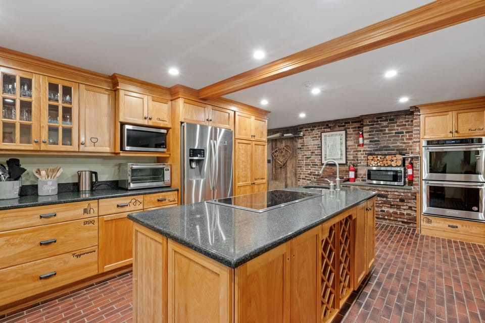 Kitchen includes wide range of appliances for cooking.