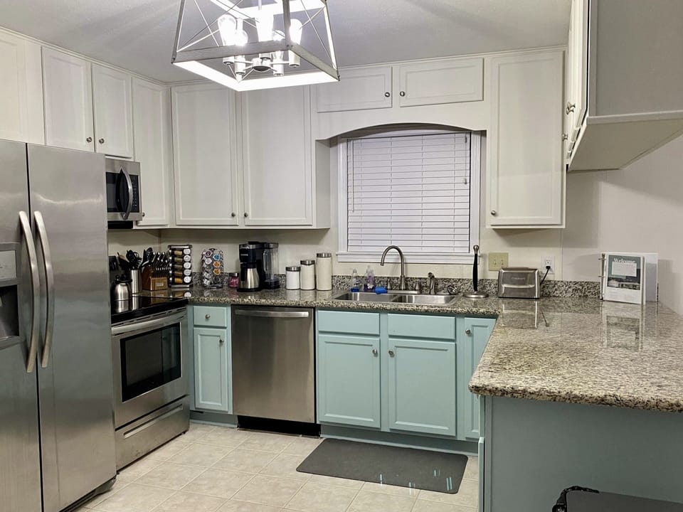Fully stocked kitchen with modern cooking utensils and appliances.