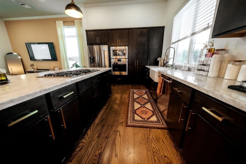 Fully stocked kitchen with stainless steel appliances.
