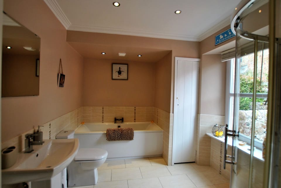 The family bathroom has a bath with separate shower cubicle