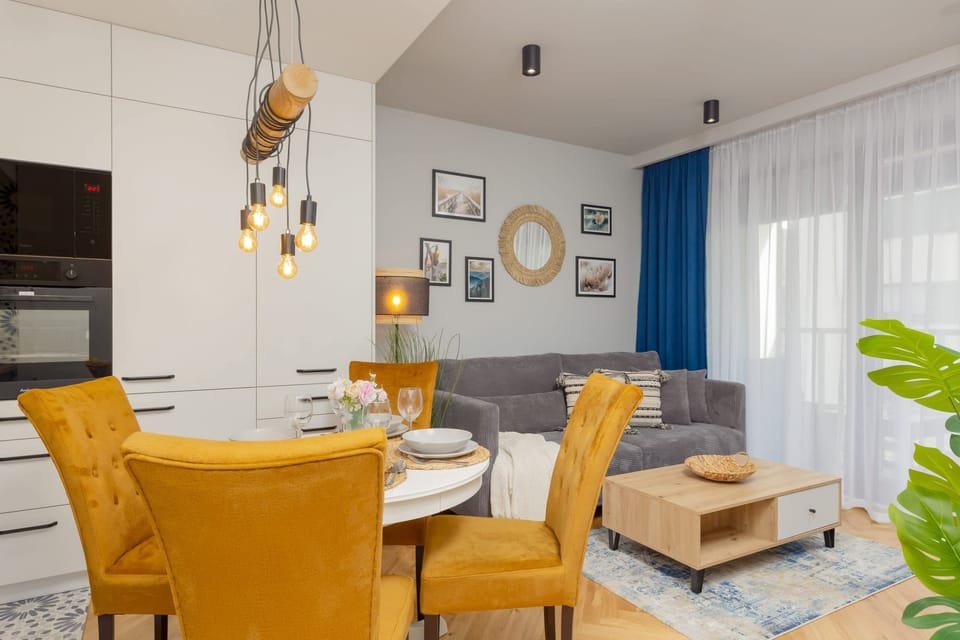 A wide-angle view of the dining and kitchen area, blending functionality with a cheerful design.
