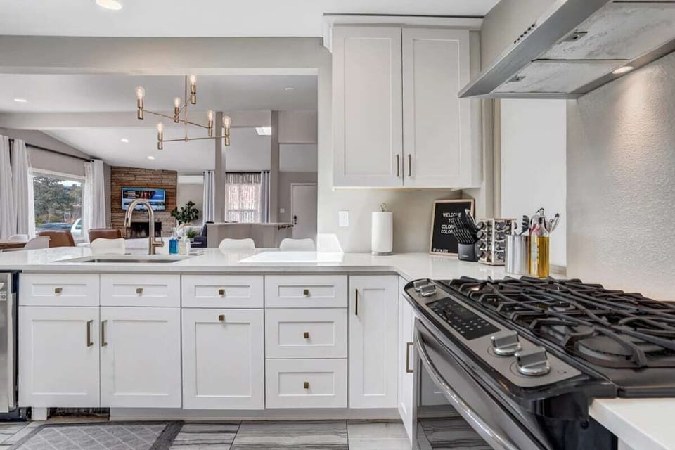Open concept living and dining area surrounded with big glass doors and window overwiewing the Pikes peak mountains will make you think to come back  and book our home again!
