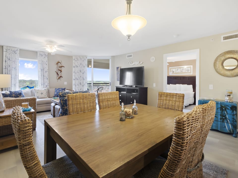 Gather around your spacious dining table for memorable meals while enjoying ocean views and comfortable wicker seating in this open-concept coastal retreat.