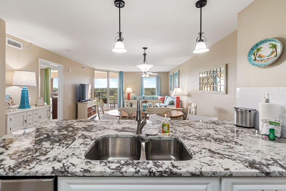 Your spacious open-concept kitchen flows seamlessly into the living area, with granite countertops and modern appliances making meal prep effortless.