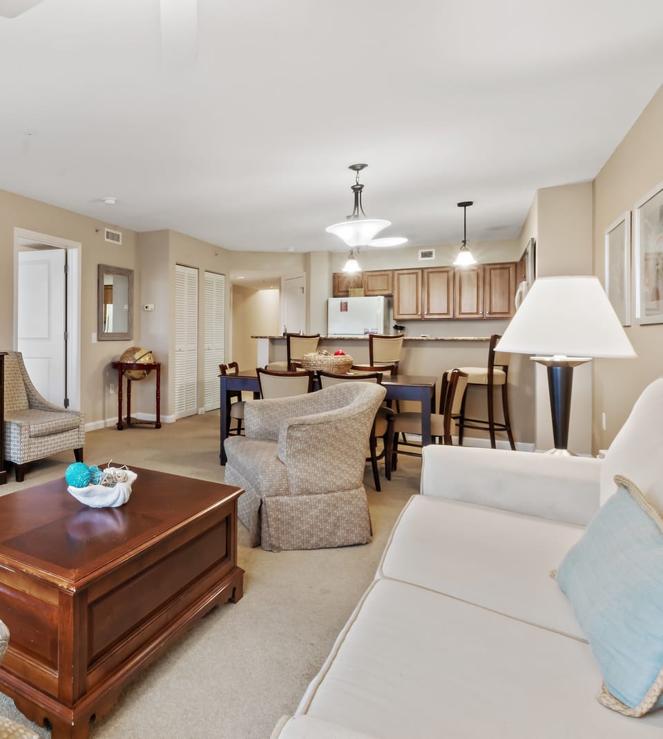 Your spacious suite combines living and dining areas seamlessly, featuring plush seating and a full kitchen for memorable gatherings.