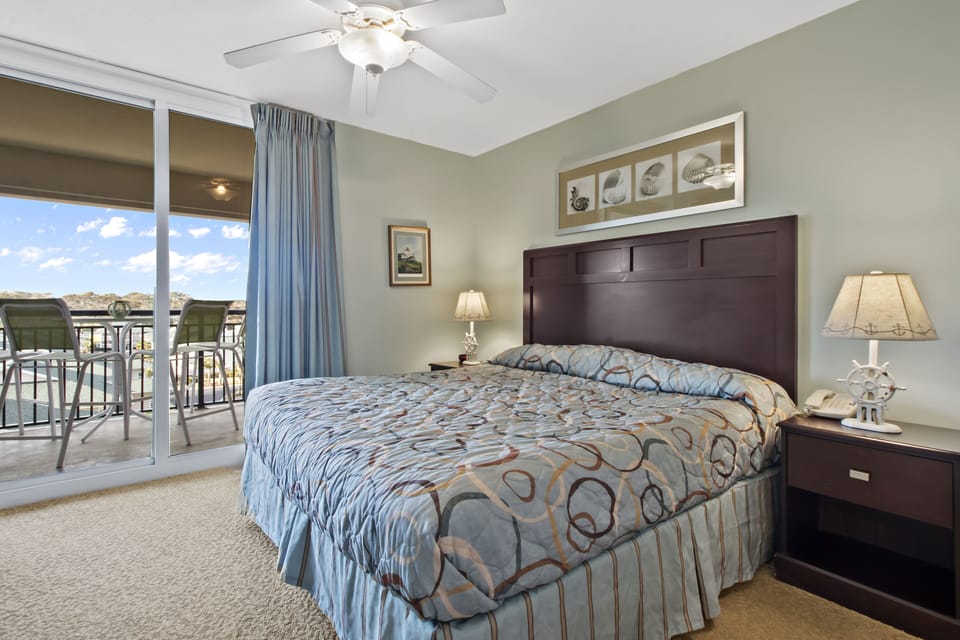 Wake up in this peaceful bedroom with your private balcony overlooking the water, where gentle breezes and morning light create the perfect start to your day.