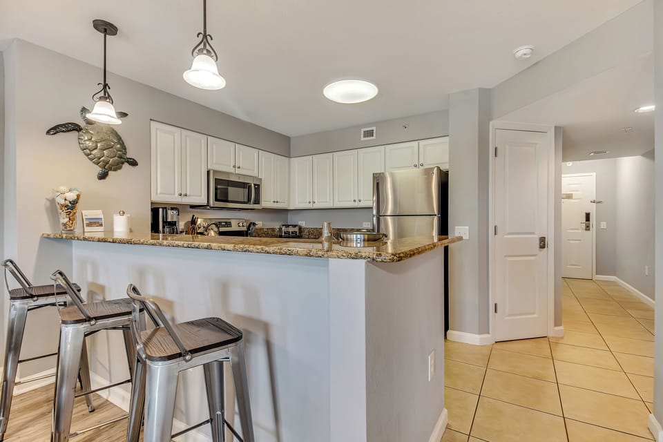 Your modern kitchen awaits with granite countertops, stainless steel appliances, and a breakfast bar perfect for morning coffee together.