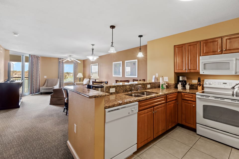Your fully equipped kitchen features granite countertops and opens to a cozy living area with beautiful mountain views.