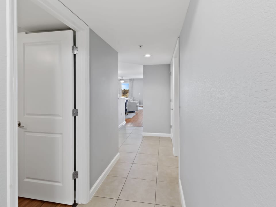 Step into your bright, modern hallway that seamlessly connects to the spacious kitchen and dining area beyond.