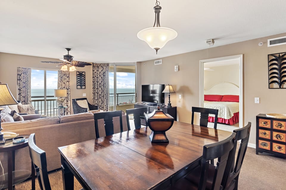 Gather around this elegant dining table where ocean views frame memorable meals with loved ones.