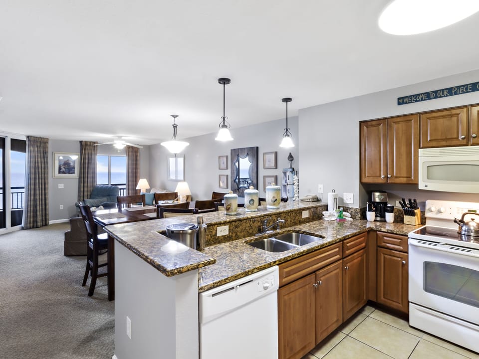 Your spacious kitchen features granite countertops and full appliances, flowing seamlessly into the comfortable living area where you can relax and dine together.