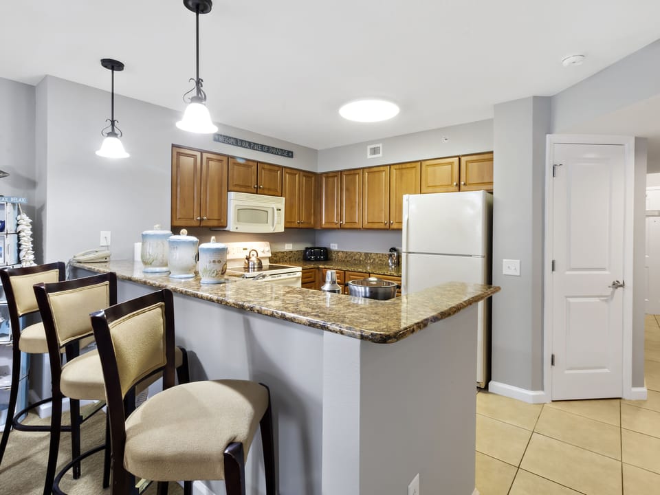 Your fully equipped kitchen invites you to cook memorable meals with granite counters, modern appliances, and breakfast bar seating.