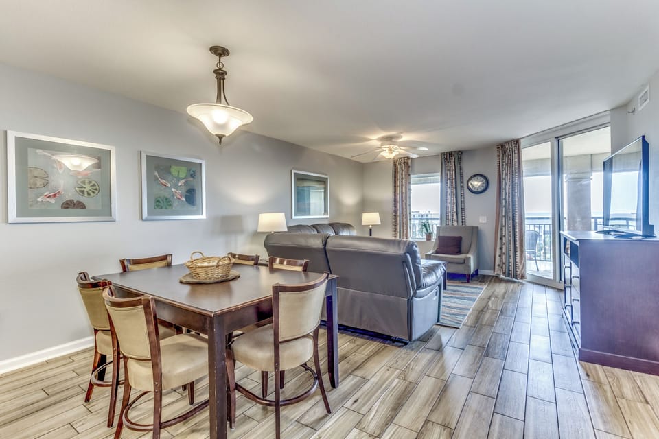 Unwind in your spacious open-plan living space featuring elegant dining for six and comfortable seating with stunning balcony views.