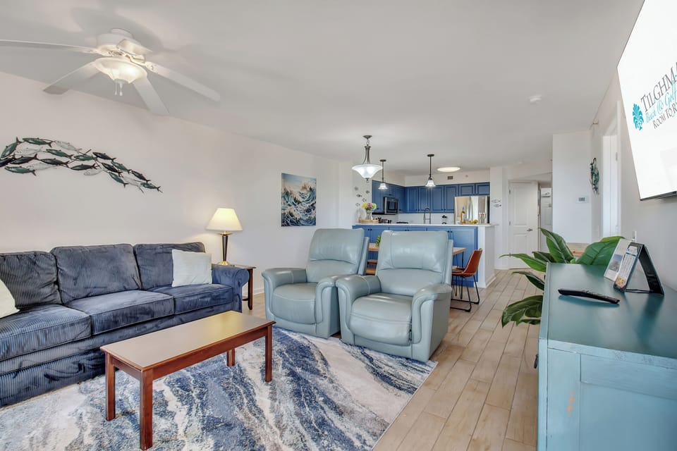 Unwind in your bright, open-concept living space with coastal-inspired decor, comfortable seating, and a fully equipped kitchen perfect for your getaway.
