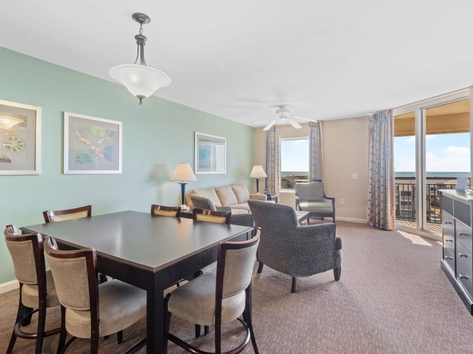 Gather around your spacious dining table while enjoying panoramic views through floor-to-ceiling windows in this elegant, light-filled suite.