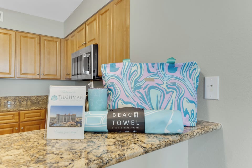 Your modern kitchen welcomes you with granite counters and thoughtful beach-themed touches, ready for cooking memorable vacation meals together.