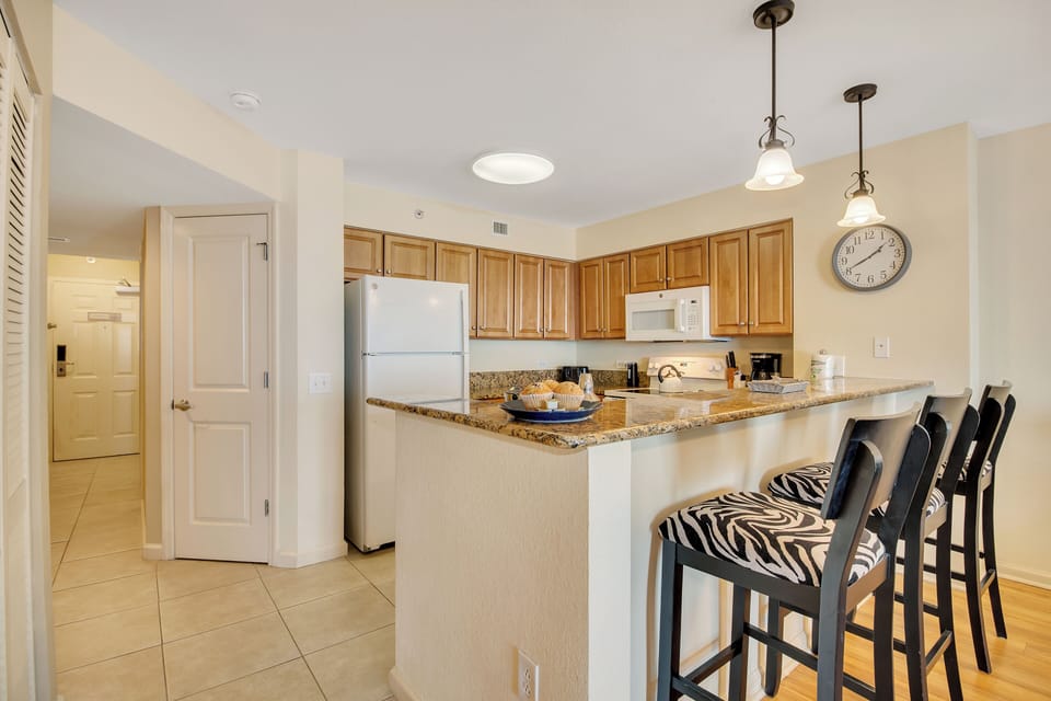 Your fully equipped kitchen features granite counters, breakfast bar seating, and all the appliances you need for home-cooked meals.