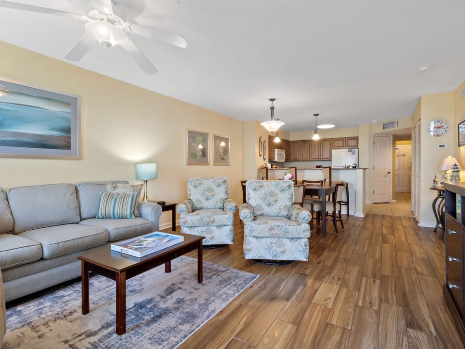 Relax in your spacious open-plan retreat with coastal charm, featuring comfortable seating and a fully equipped kitchen for your convenience.