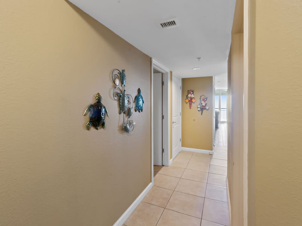 Stroll through your bright hallway adorned with charming sea life artwork that brings coastal warmth to your space.