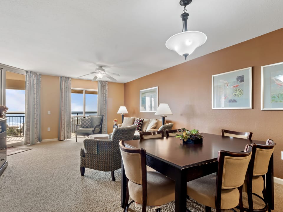 Your spacious living area flows seamlessly into elegant dining space, perfect for memorable meals with panoramic balcony views.