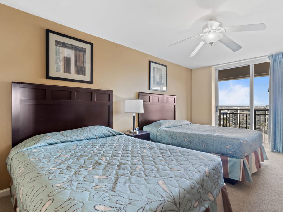 Relax in your comfortable bedroom with twin beds and enjoy city views from your private balcony.