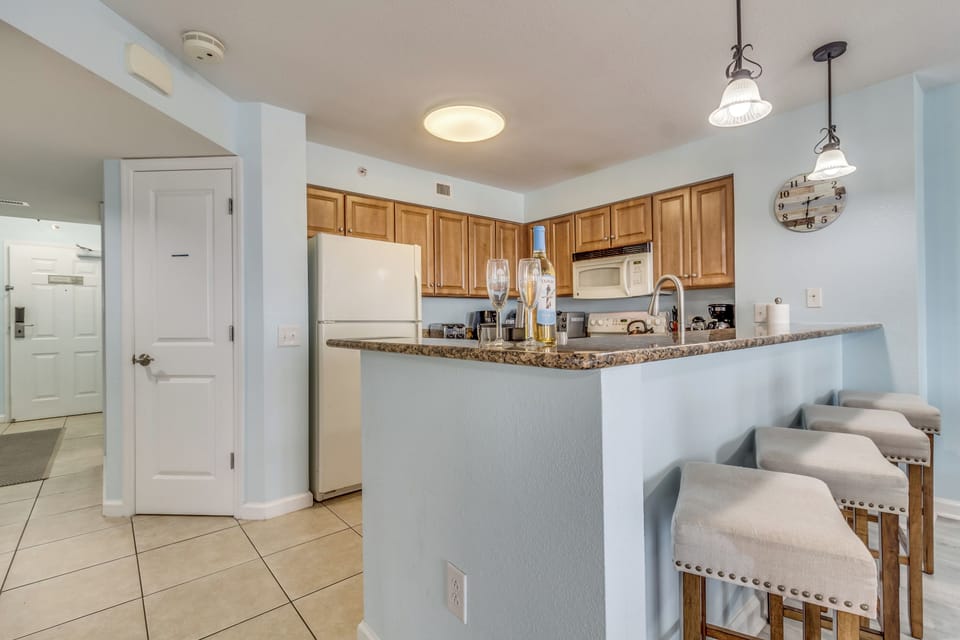 Your open kitchen features granite countertops, modern appliances, and a breakfast bar where you can enjoy morning coffee or casual meals together.