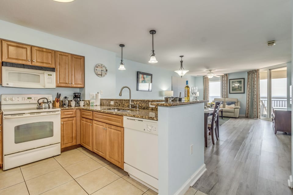 Your spacious open-plan kitchen flows seamlessly into the living area, where you'll love preparing meals with granite counters and modern appliances.