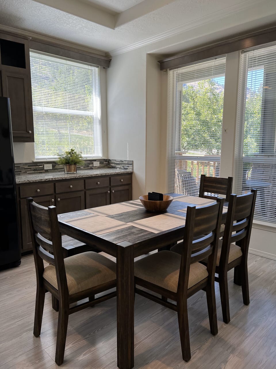 Windows wrap around kitchen area and in living room