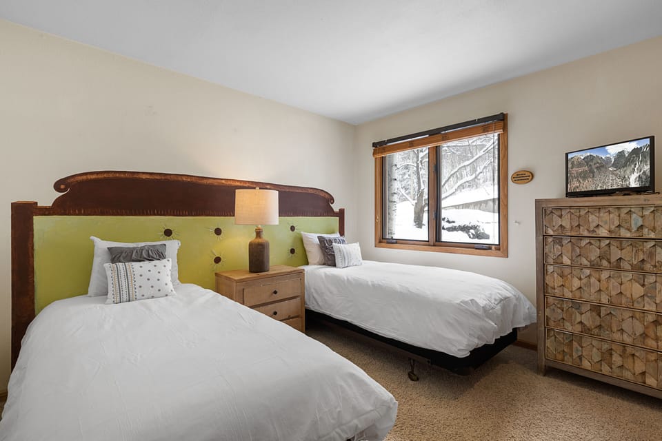 Bedroom 2 features two twin beds.