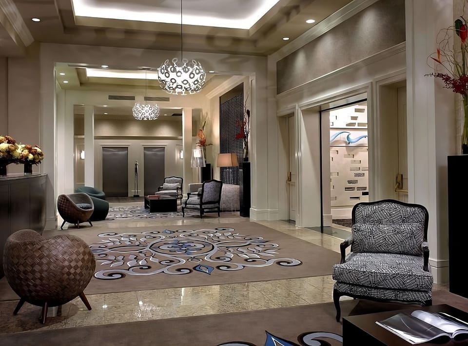 Arrive in style beneath statement lighting and elegant lounge seating.
