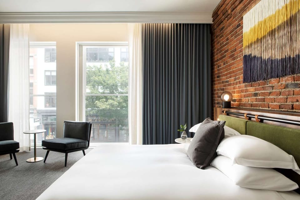 Stretch out by sunlit windows beside a warm brick accent wall.