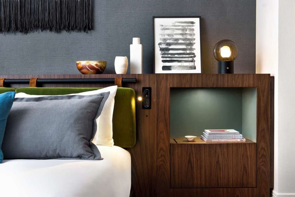 Wake up to sleek design details and cozy bedside lighting.
