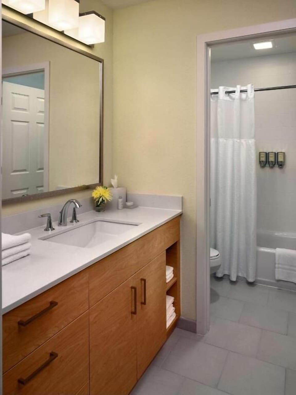 Rinse away travel fatigue in a bright, tidy bathroom.