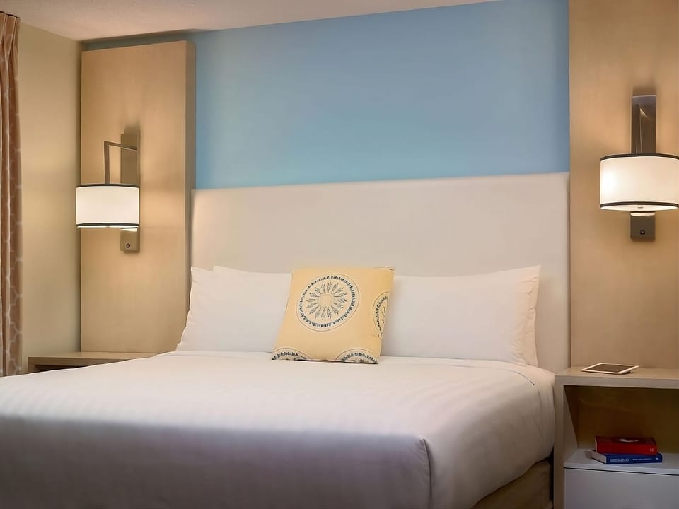 Relax in plush bedding beneath soft, glowingly warm bedside lamps.