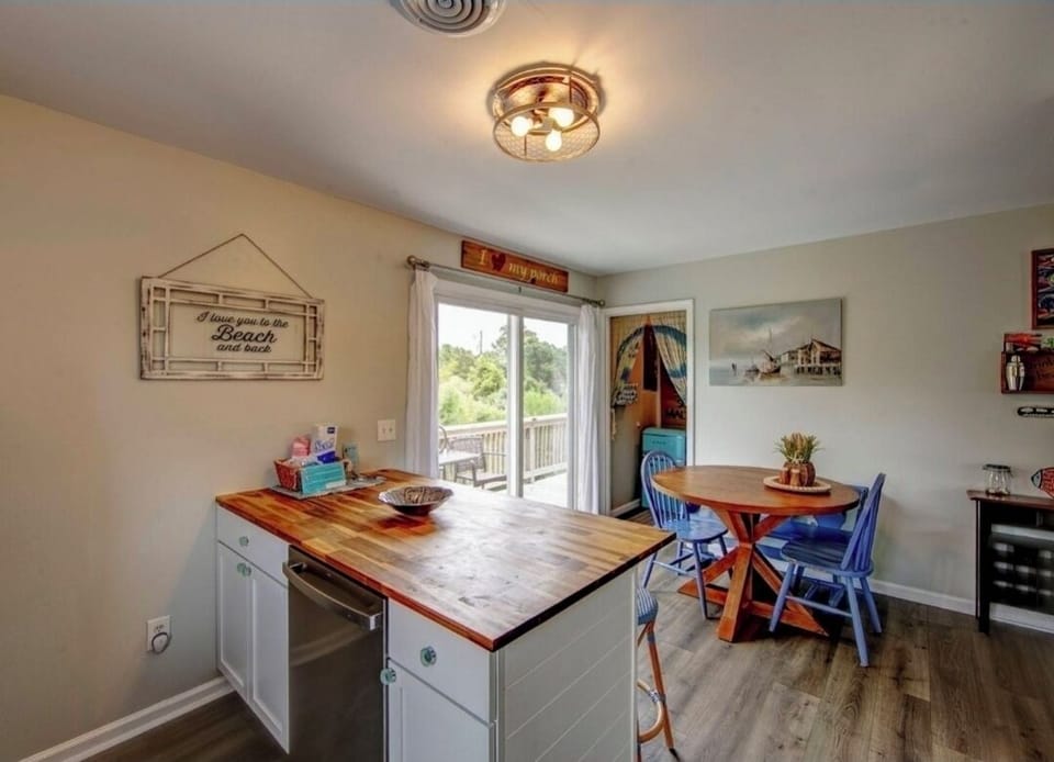 Your bright, beach-themed kitchen invites you to prepare meals at the spacious island while natural light streams through doors opening to your private balcony. Coastal charm meets comfort with cheerful decor and relaxed dining for memorable mornings toget