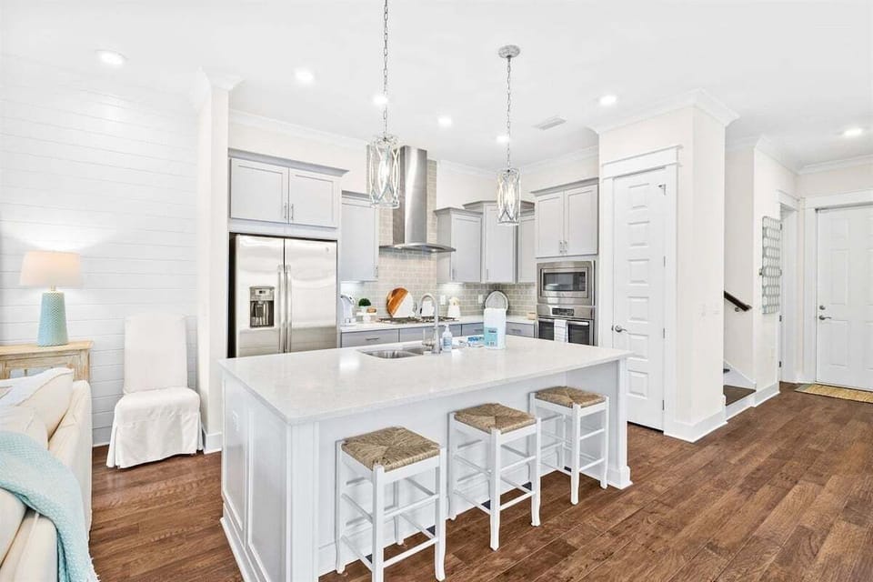 A fully equipped, modern kitchen with an island for casual dining and meal prep.