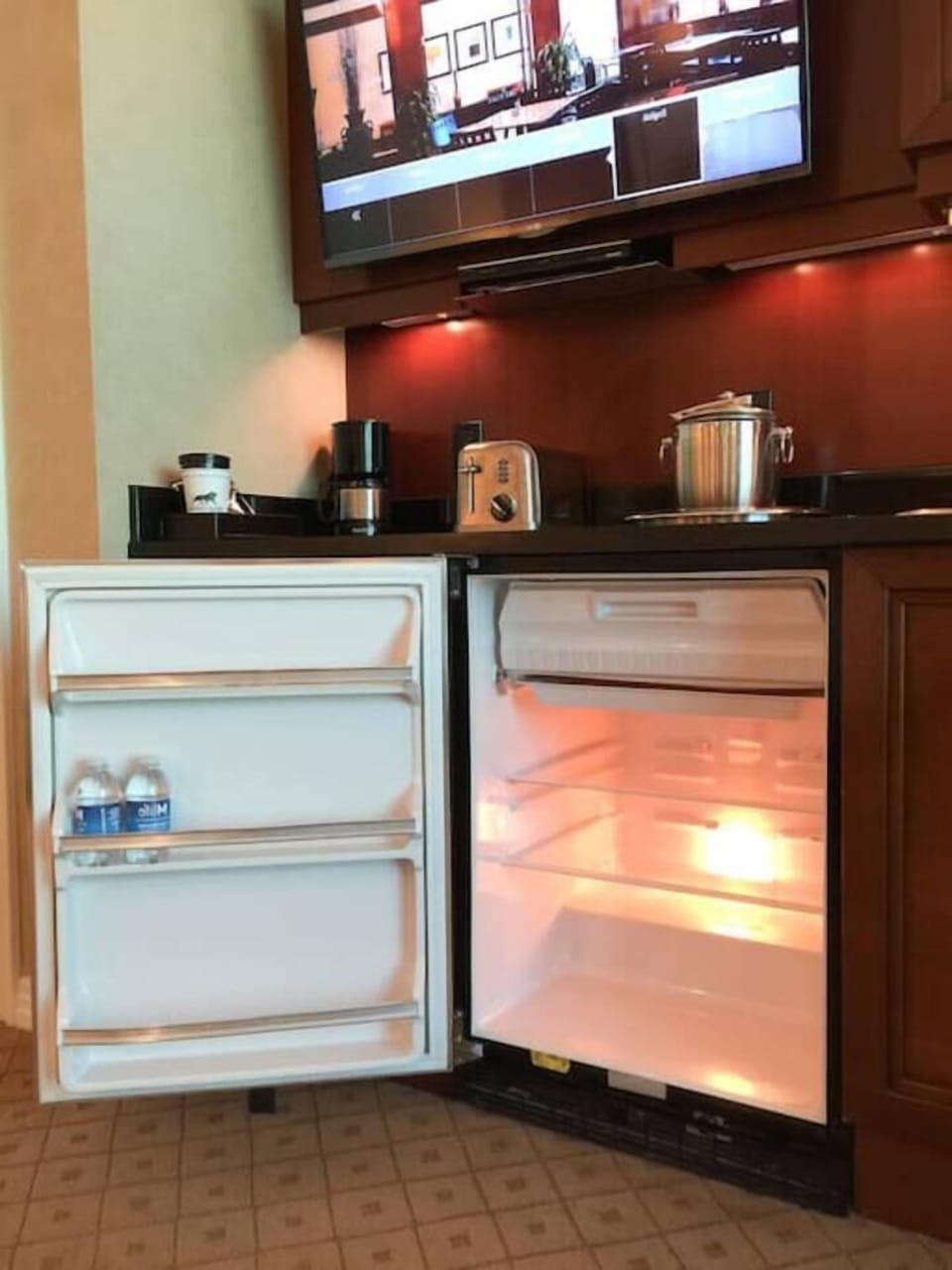 The fridge has been upgraded to a glass-door fridge. There is no freezer compartment.