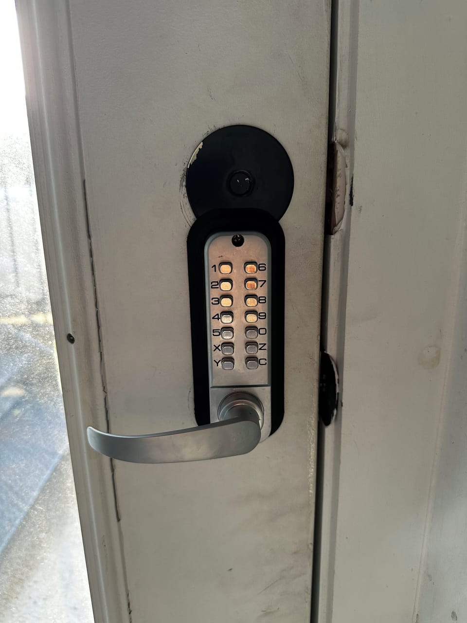 Lock on door in breezeway to access alley and trash bins