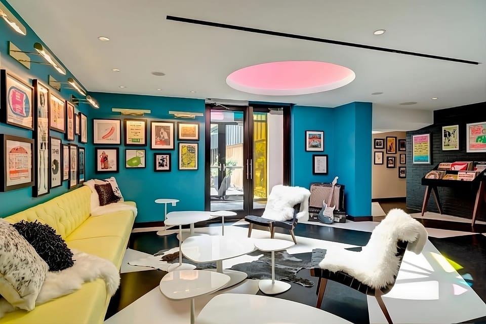 Gather in the vibrant lounge beneath the glowing skylight.