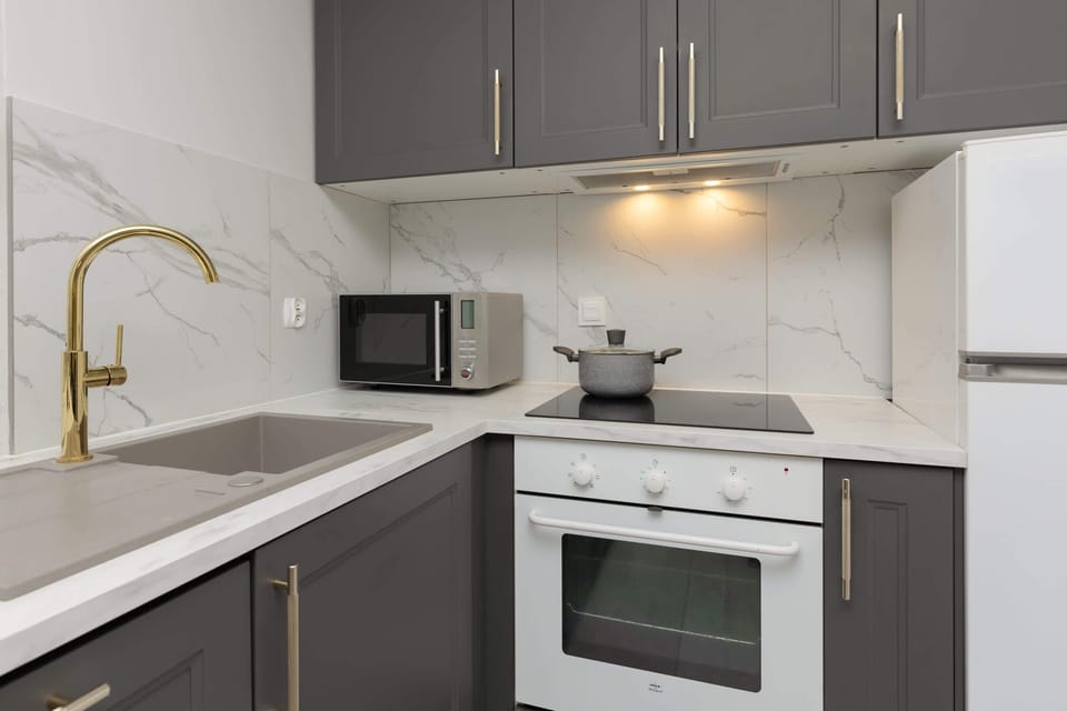 A modern kitchen setup with built-in appliances, ample storage, and clean design lines.