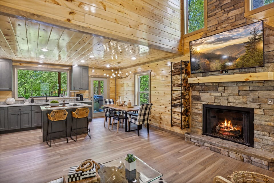 View of living room, fire place, and kitchen - View from the living room of the gas fire place, kitchen and dining area