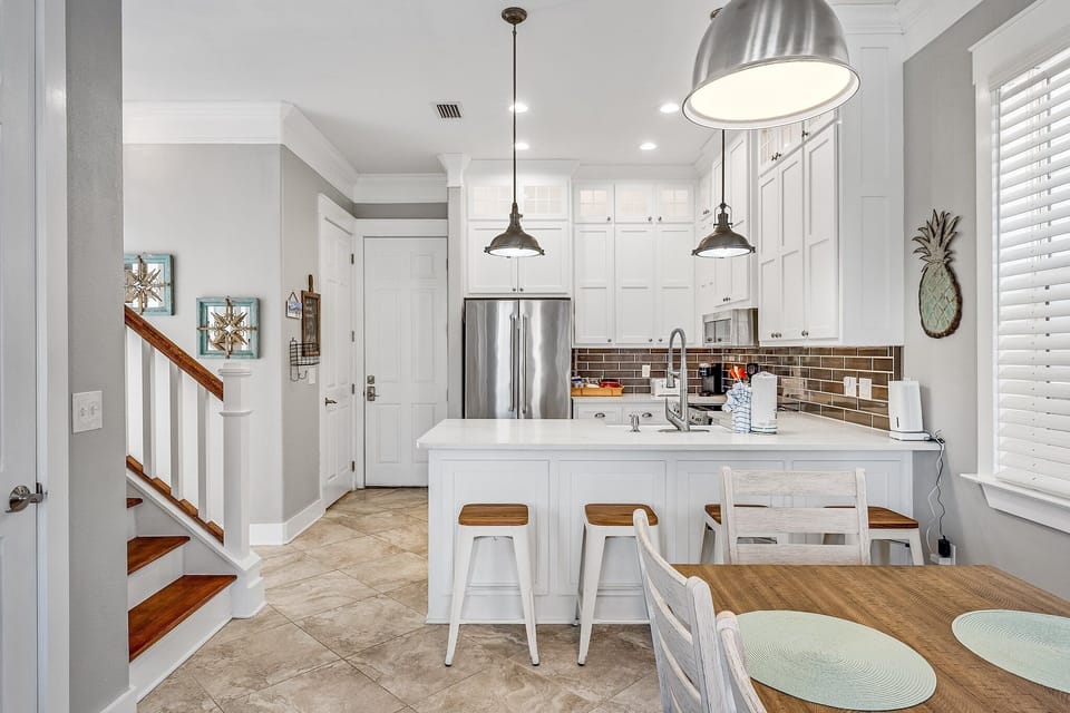 You'll love cooking in this bright, modern kitchen with stainless appliances, granite counters, and charming coastal touches throughout.