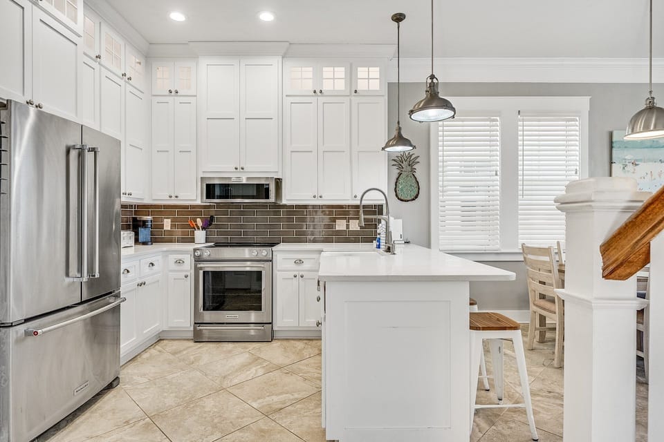 Cook memorable meals in this bright, fully-equipped kitchen with stainless steel appliances, quartz counters, and a charming breakfast bar.