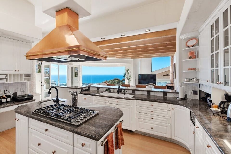 Spacious kitchen with double ovens, gas stove with a one of a kind copper vent