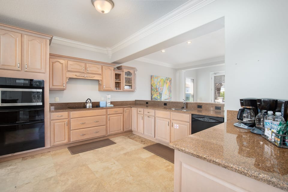 Your spacious kitchen awaits with granite countertops, warm wood cabinets, and all modern appliances to create memorable meals together.