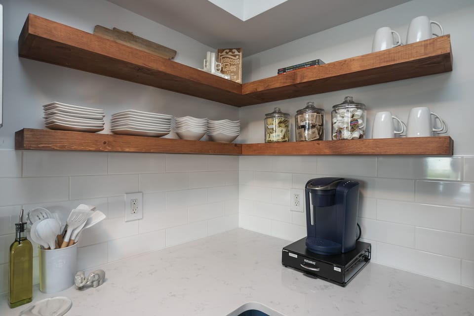 Coffee bar with Keurig coffee maker, coffee, tea, & sweeter. 